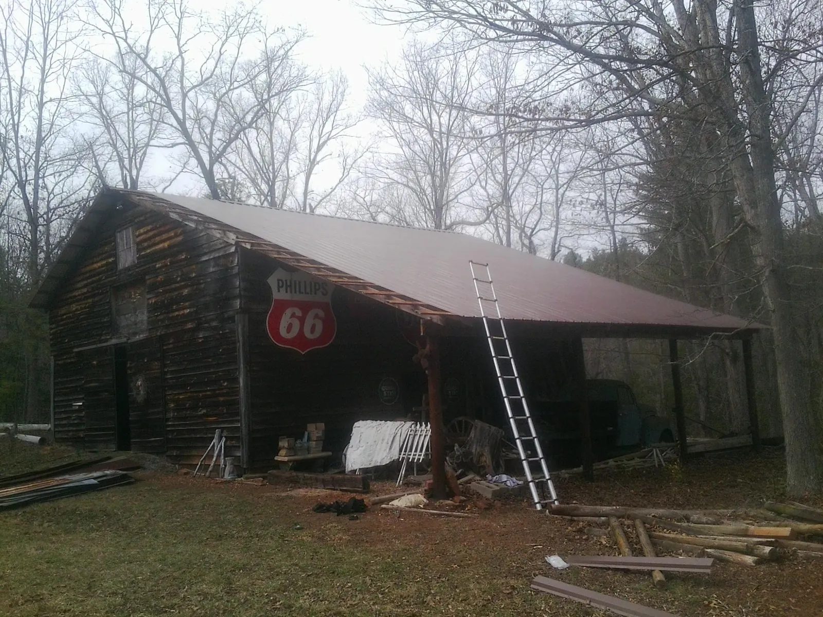 New metal roof on an open sided timber barn with a vintage sign in Central Square
